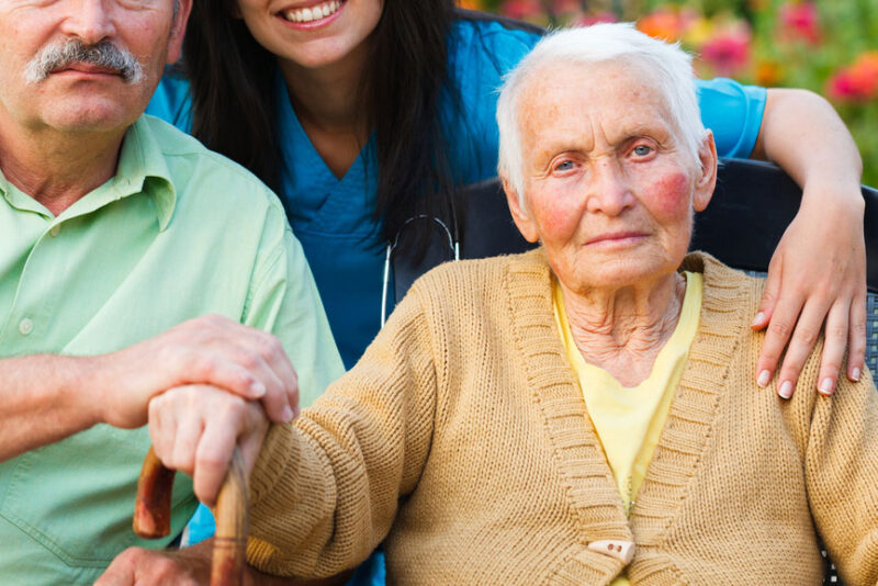 An old woman with red cheeks glares at the camera