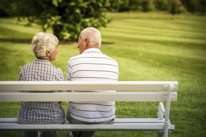 couple sitting on a park bench